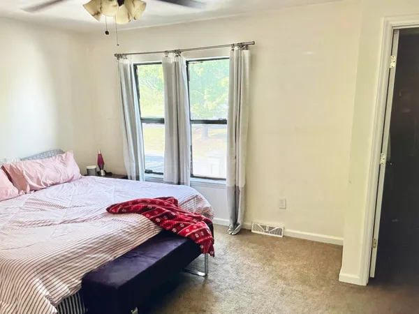 a bedroom with a bed and a window