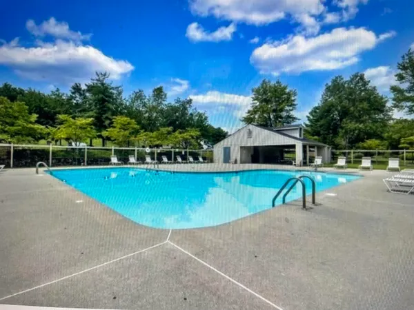 a view of a swimming pool with a yard