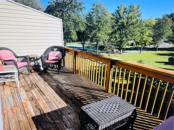 a view of a wooden deck with furniture