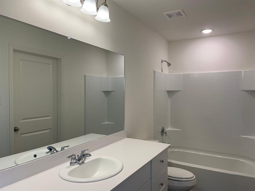 1911 Chapel Hill Road Princeton, TX 75407 - Photo 7 of 14 a bathroom with a sink a toilet and shower