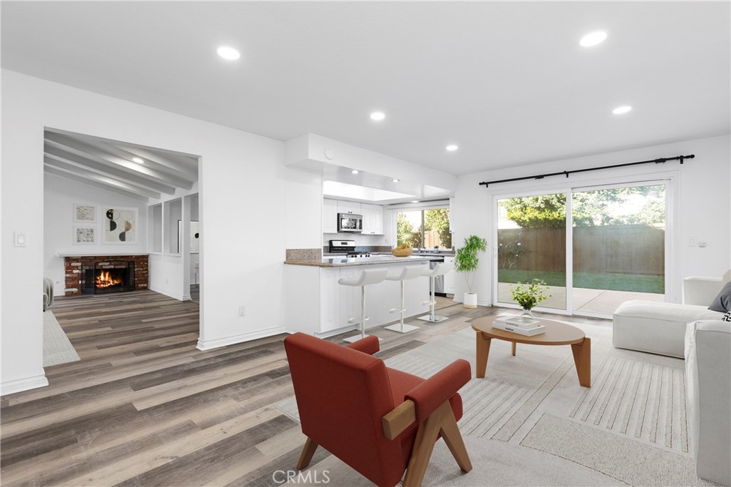 7 Chattanooga Irvine, CA 92620 - Photo 7 of 24 a living room with fireplace furniture and a view of kitchen