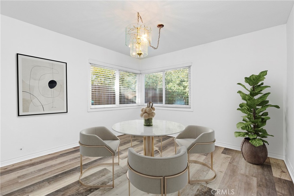 7 Chattanooga Irvine, CA 92620 - Photo 8 of 24 a dining room with furniture potted plants and wooden floor