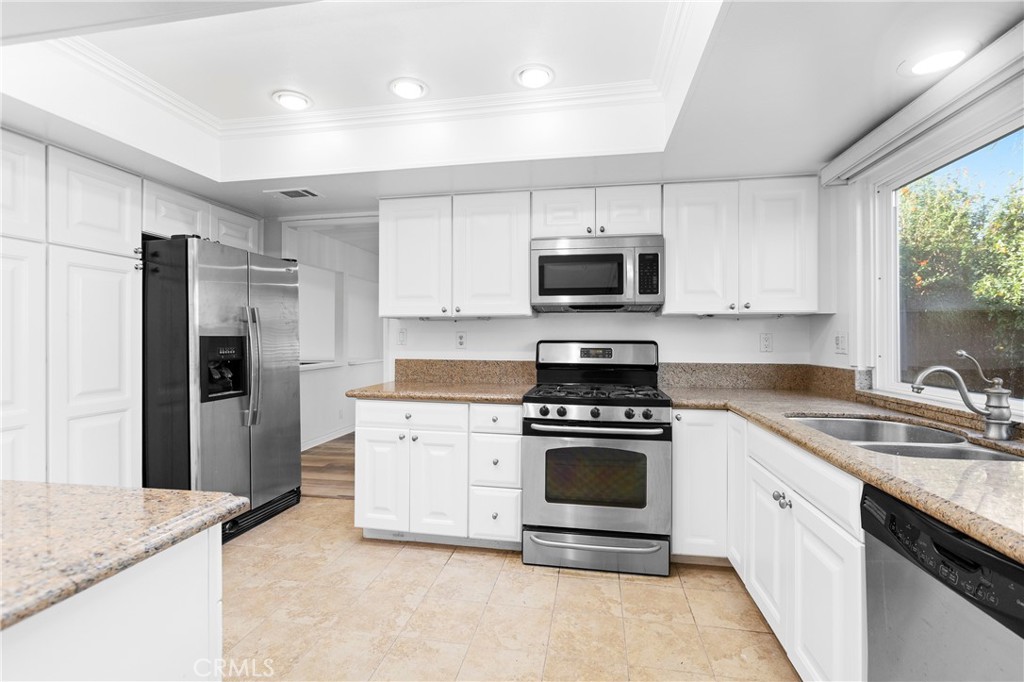7 Chattanooga Irvine, CA 92620 - Photo 10 of 24 a kitchen with a stove a sink and a refrigerator
