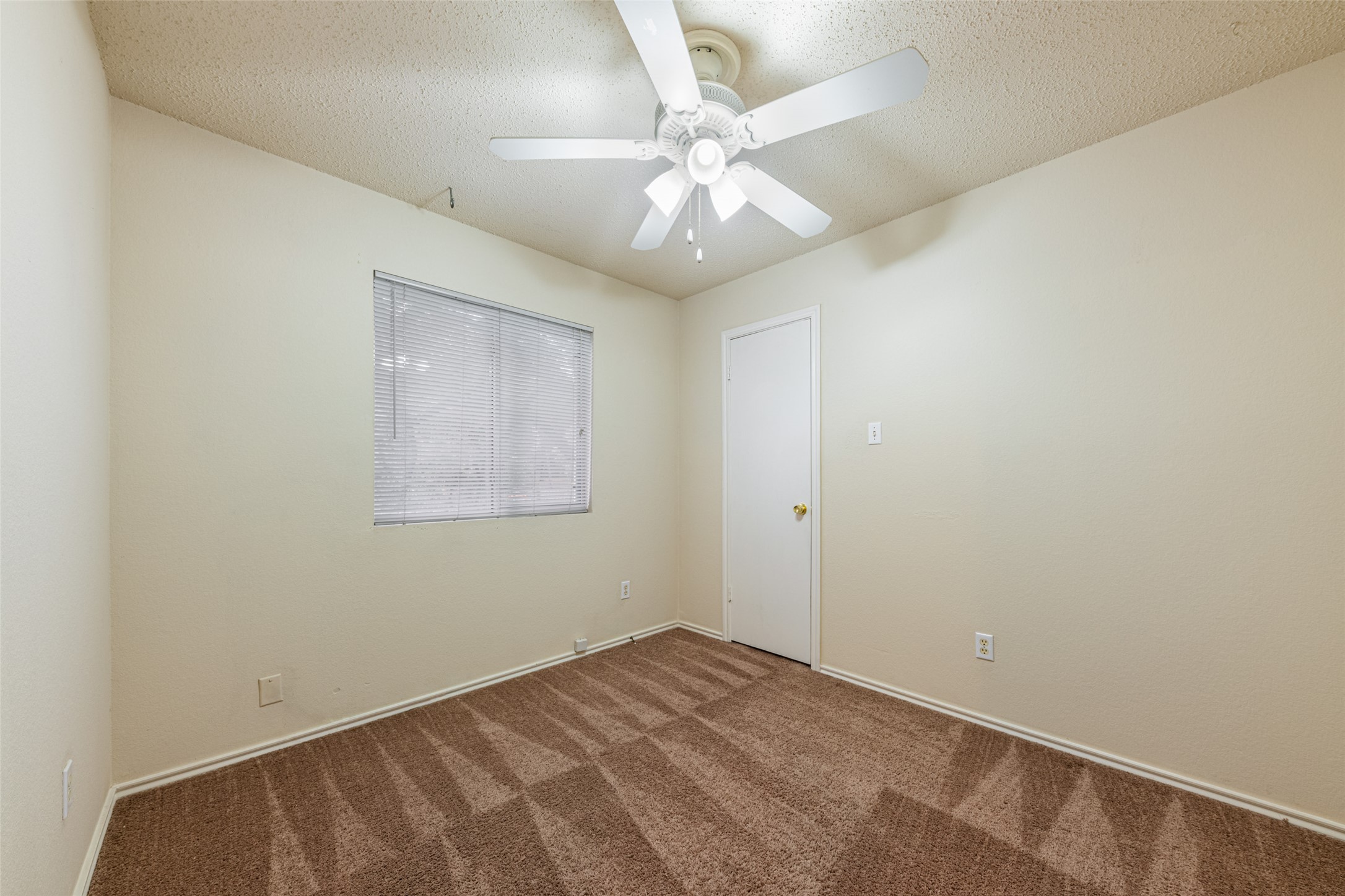 7216 Aldea Drive, Unit A Austin, TX 78745 - Photo 15 of 25 Neutral-toned walls complement patterned carpeting