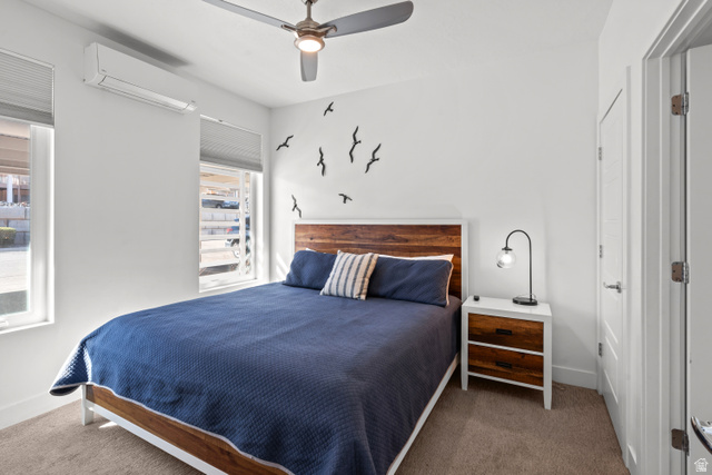 1122 South 1790th Street West, Unit 2 St. George, UT 84770 - Photo 7 of 37 Bedroom featuring a wood-finish headboard, individual climate control unit, two windows with blinds, a ceiling fan with integrated lighting, and carpeted flooring