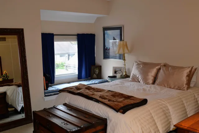 a bedroom with a bed and a dresser