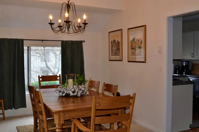 a view of a dining room with furniture and window