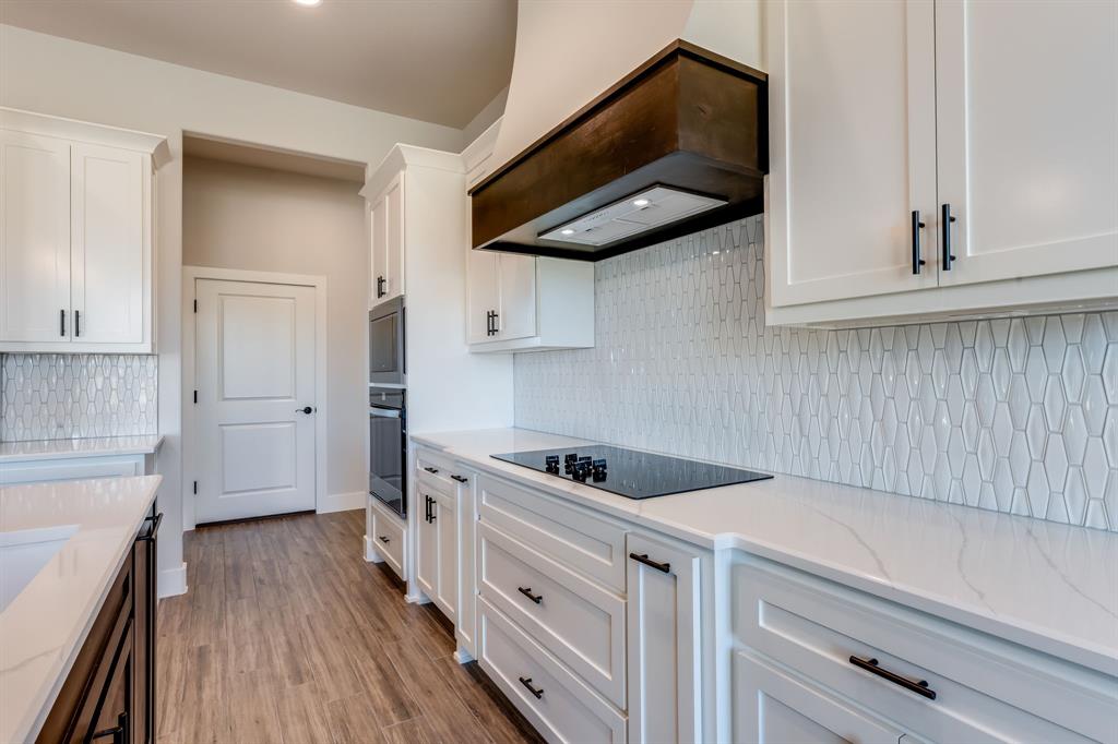 7017 Rnch Vw Place Springtown, TX 76082 - Photo 9 of 38 a kitchen with stainless steel appliances granite countertop a sink a stove and cabinets