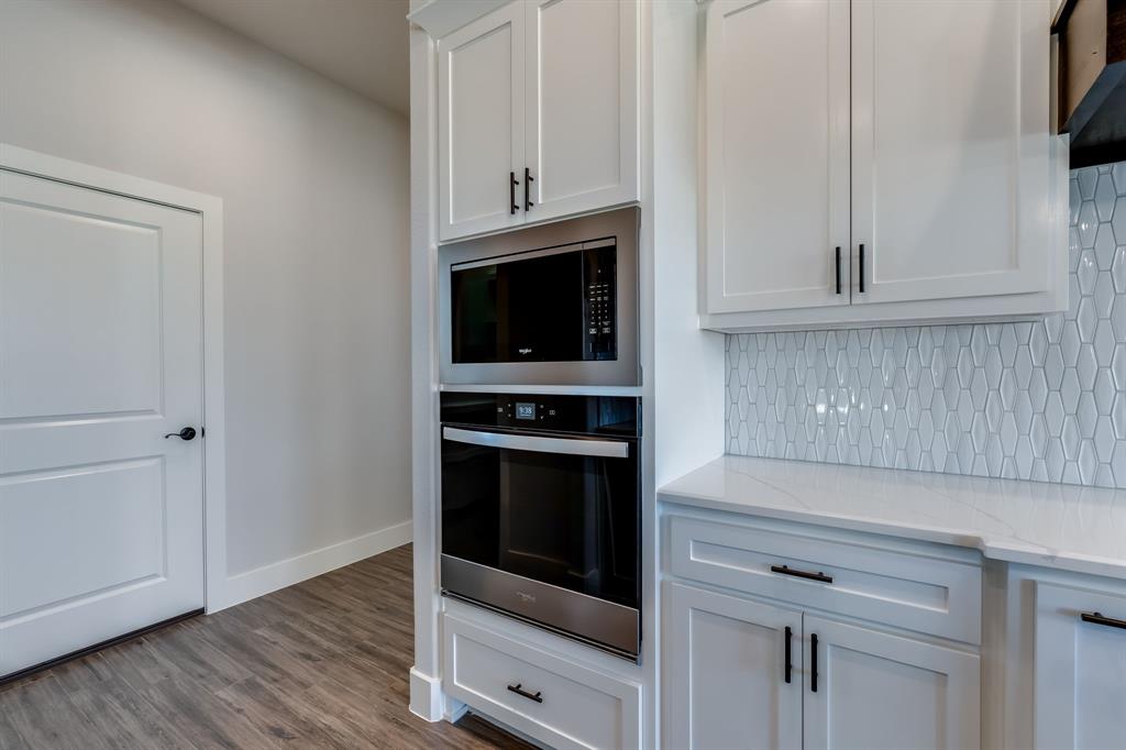 7017 Rnch Vw Place Springtown, TX 76082 - Photo 10 of 38 a kitchen with cabinets and steel appliances