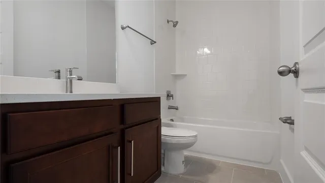 a bathroom with a bathtub sink vanity mirror and toilet