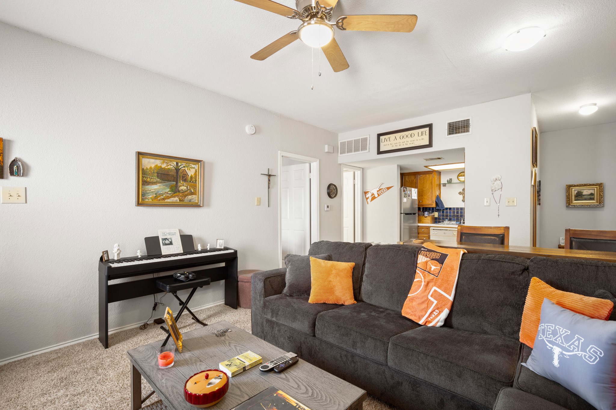 706 West 22nd Street, Unit 206 Austin, TX 78705 - Photo 4 of 18 Living area featuring ceiling fan and carpet floors