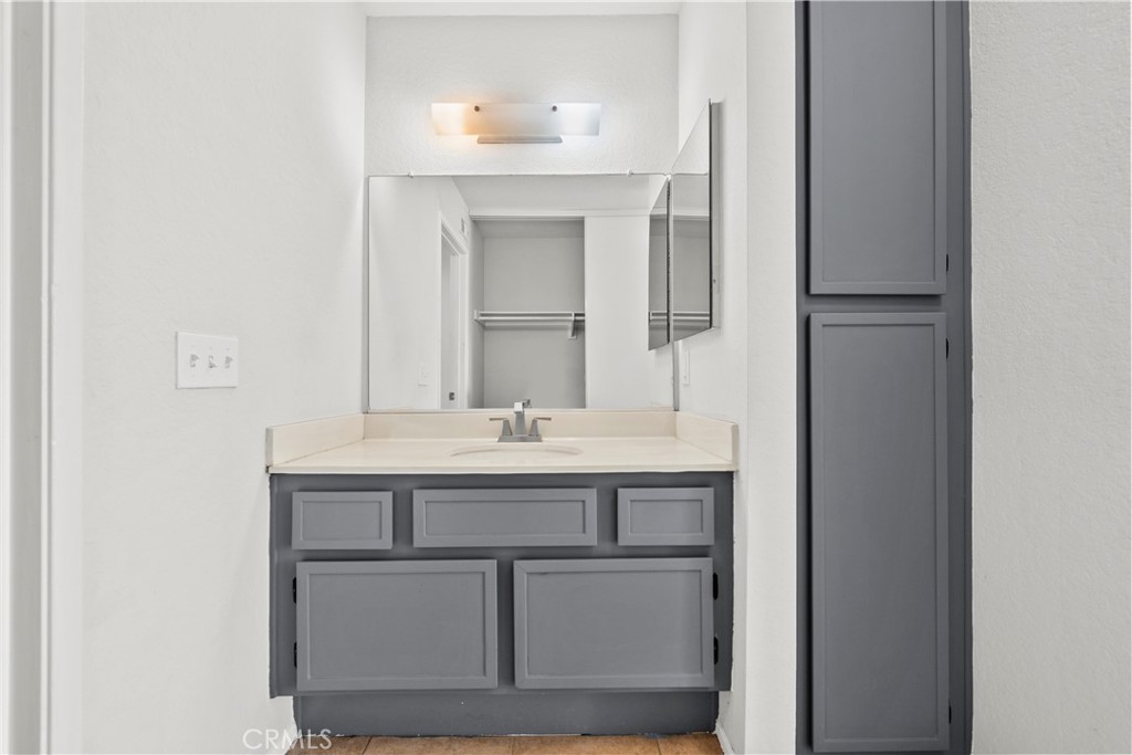 2554 Olive Drive, Unit 116 Palmdale, CA 93550 - Photo 16 of 26 a bathroom with a sink and a mirror