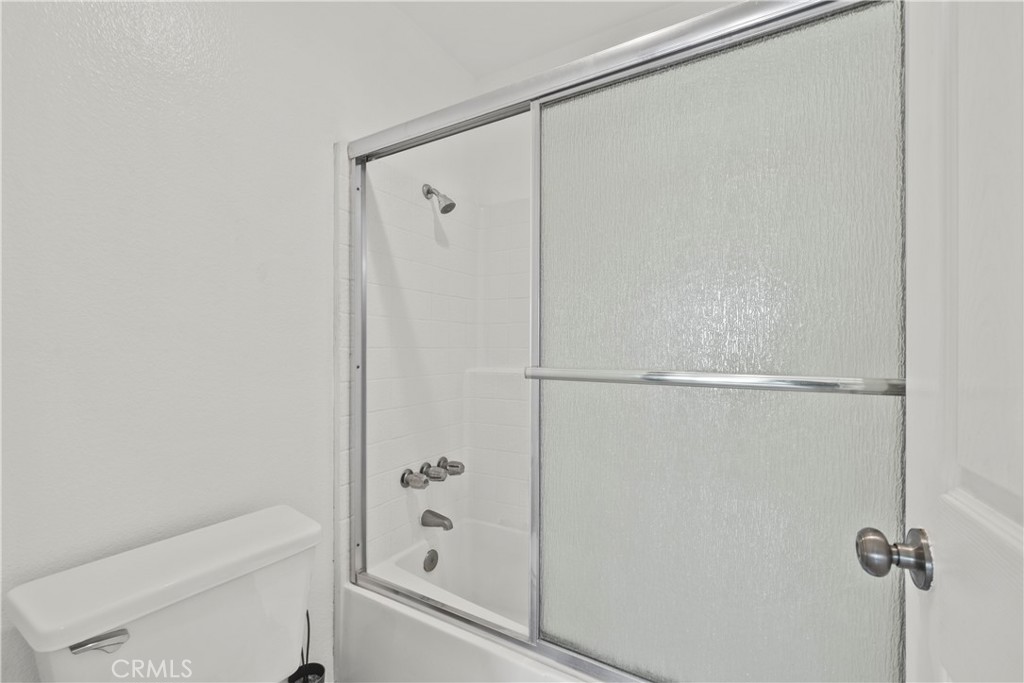 2554 Olive Drive, Unit 116 Palmdale, CA 93550 - Photo 17 of 26 a bathroom with a shower and a toilet