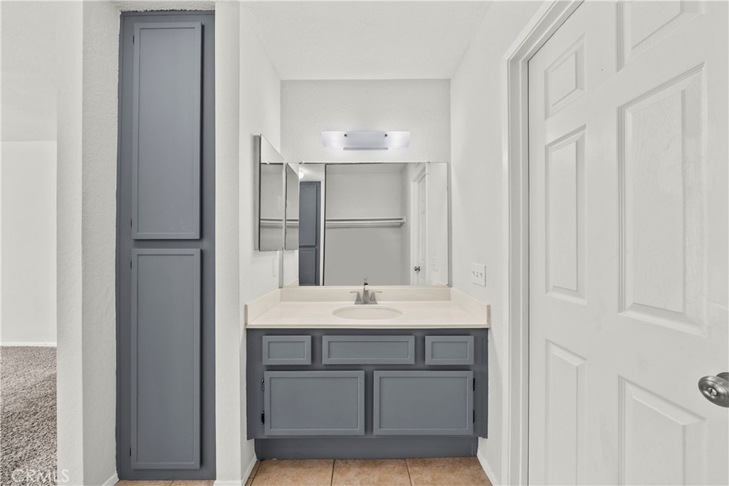 2554 Olive Drive, Unit 116 Palmdale, CA 93550 - Photo 22 of 26 a bathroom with a sink and a mirror