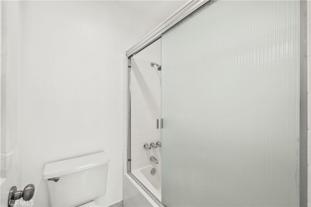 2554 Olive Drive, Unit 116 Palmdale, CA 93550 - Photo 23 of 26 a bathroom with a granite countertop sink a toilet and shower
