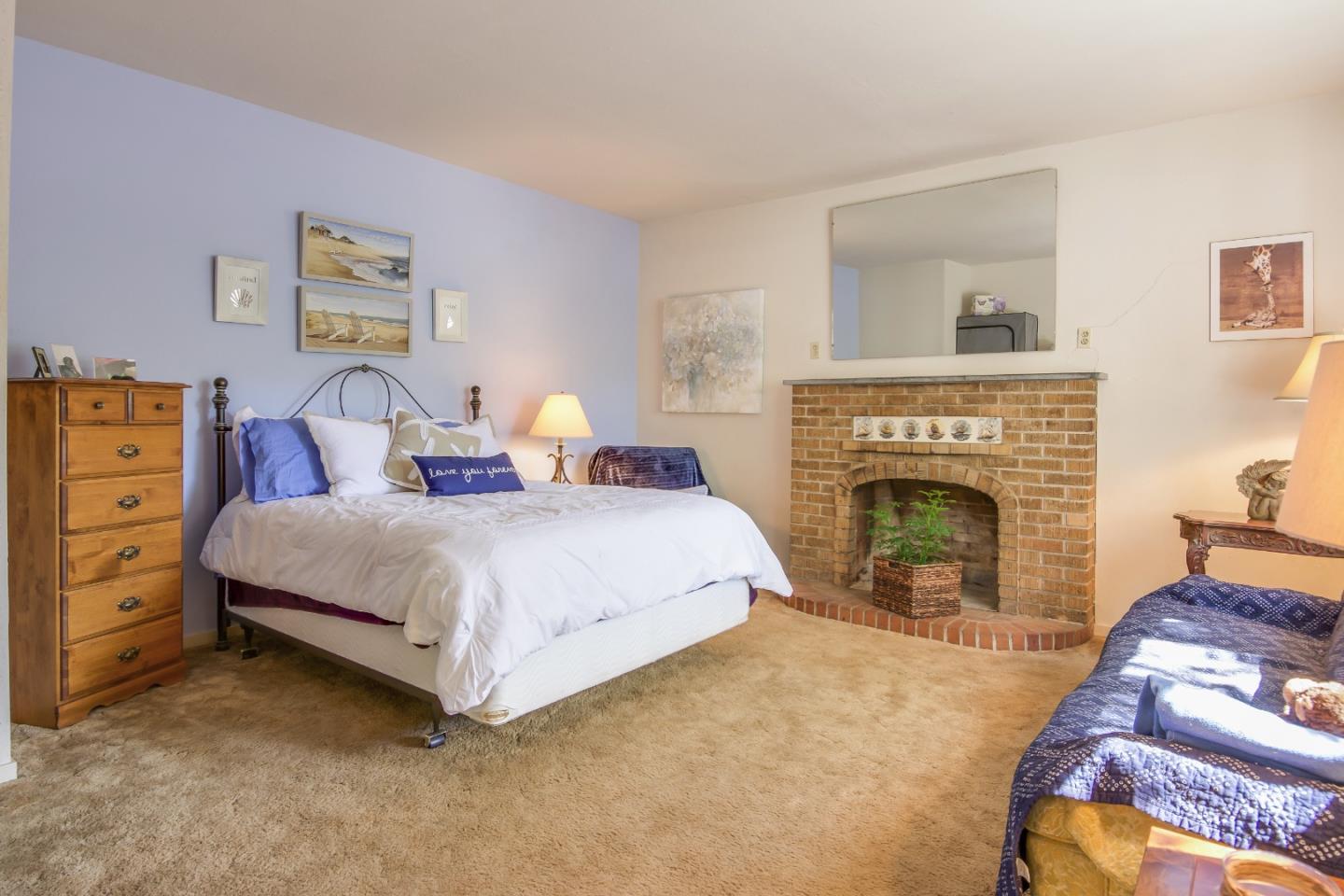 91 Marsh Road Atherton, CA 94027 - Photo 4 of 20 a bedroom with a bed and a fireplace