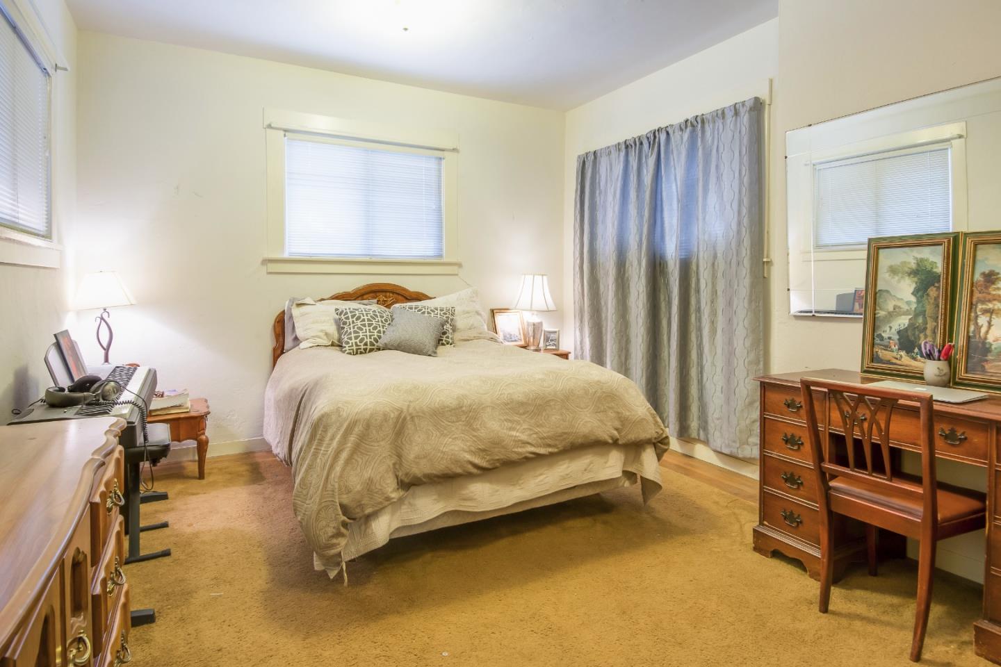 91 Marsh Road Atherton, CA 94027 - Photo 10 of 20 a bedroom with a bed a table and a dresser