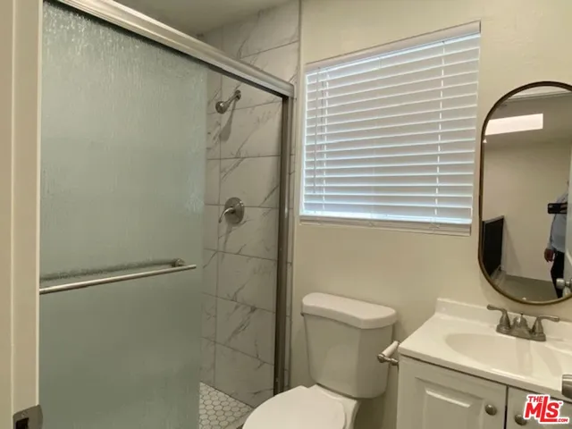 a bathroom with a toilet sink and shower