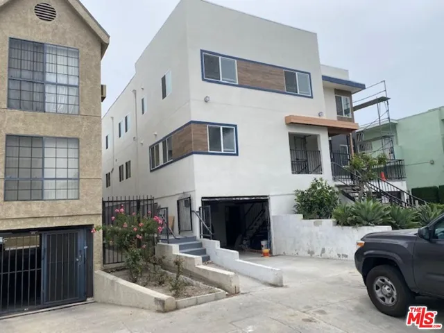 a car parked in front of white building