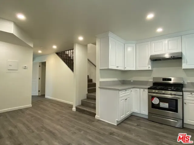 a kitchen with a stove a sink and a refrigerator