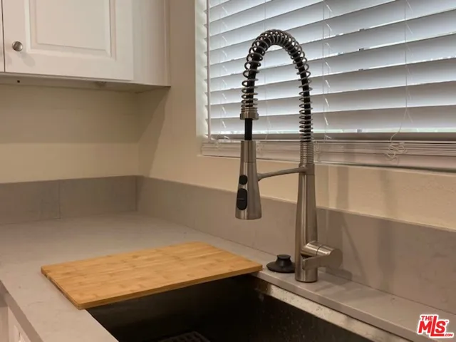a room with a wooden floor and white cabinet
