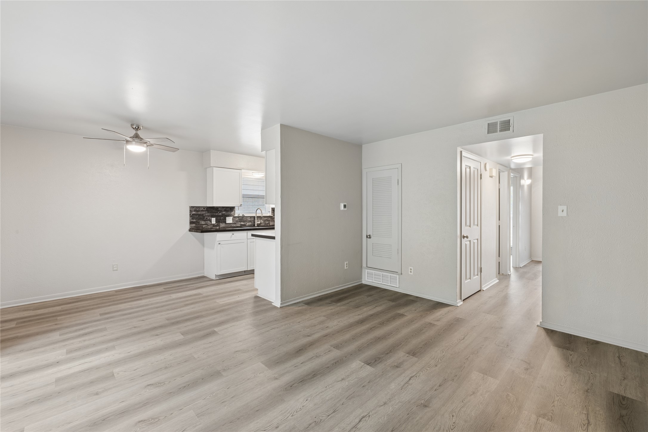 820 Sahara Avenue, Unit B Austin, TX 78745 - Photo 4 of 29 Unfurnished living room with ceiling fan and light wood-style flooring