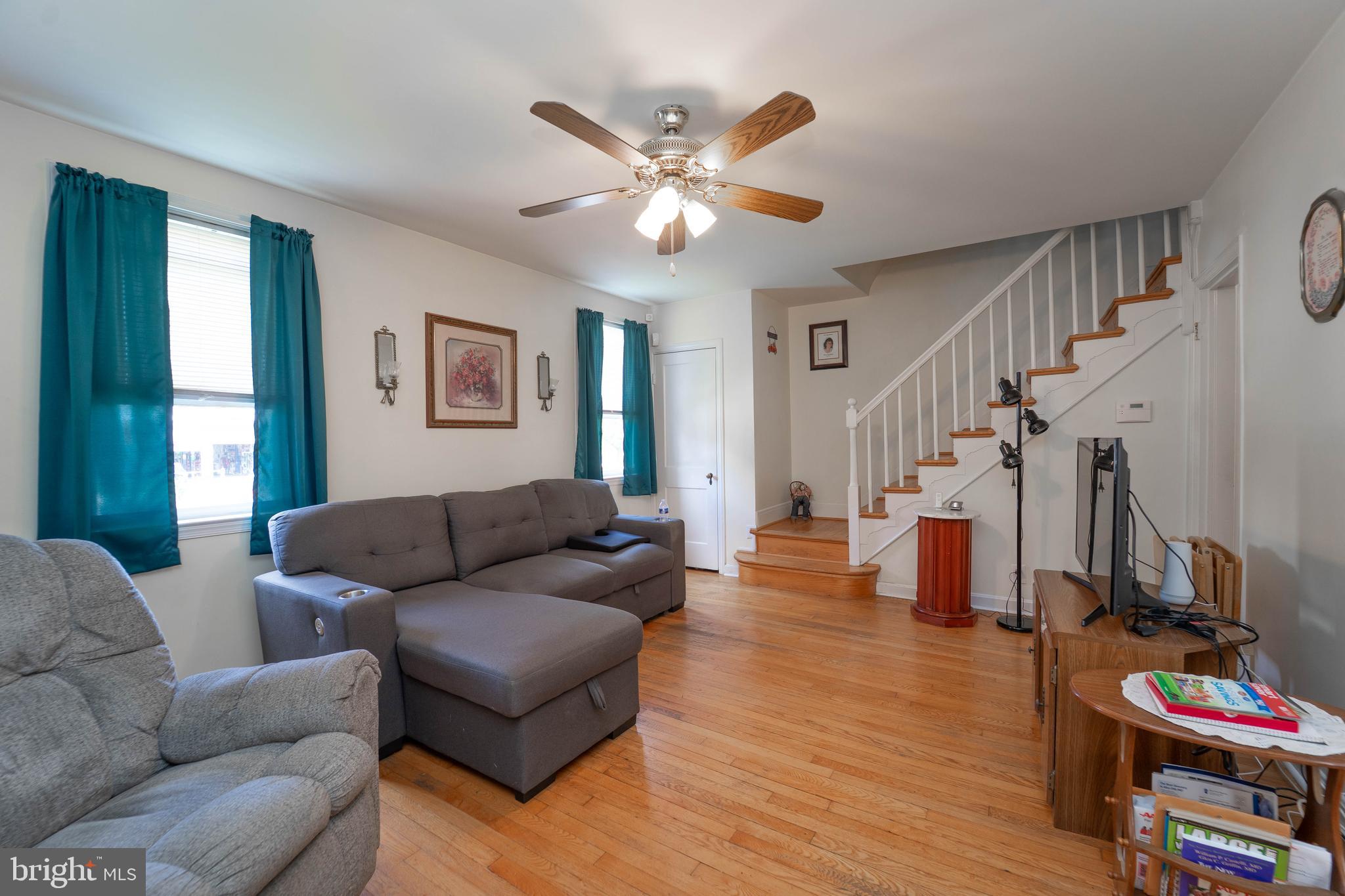 6515 Frederick Road Catonsville, MD 21228 - Photo 14 of 30 a living room with furniture a ceiling fan and a window