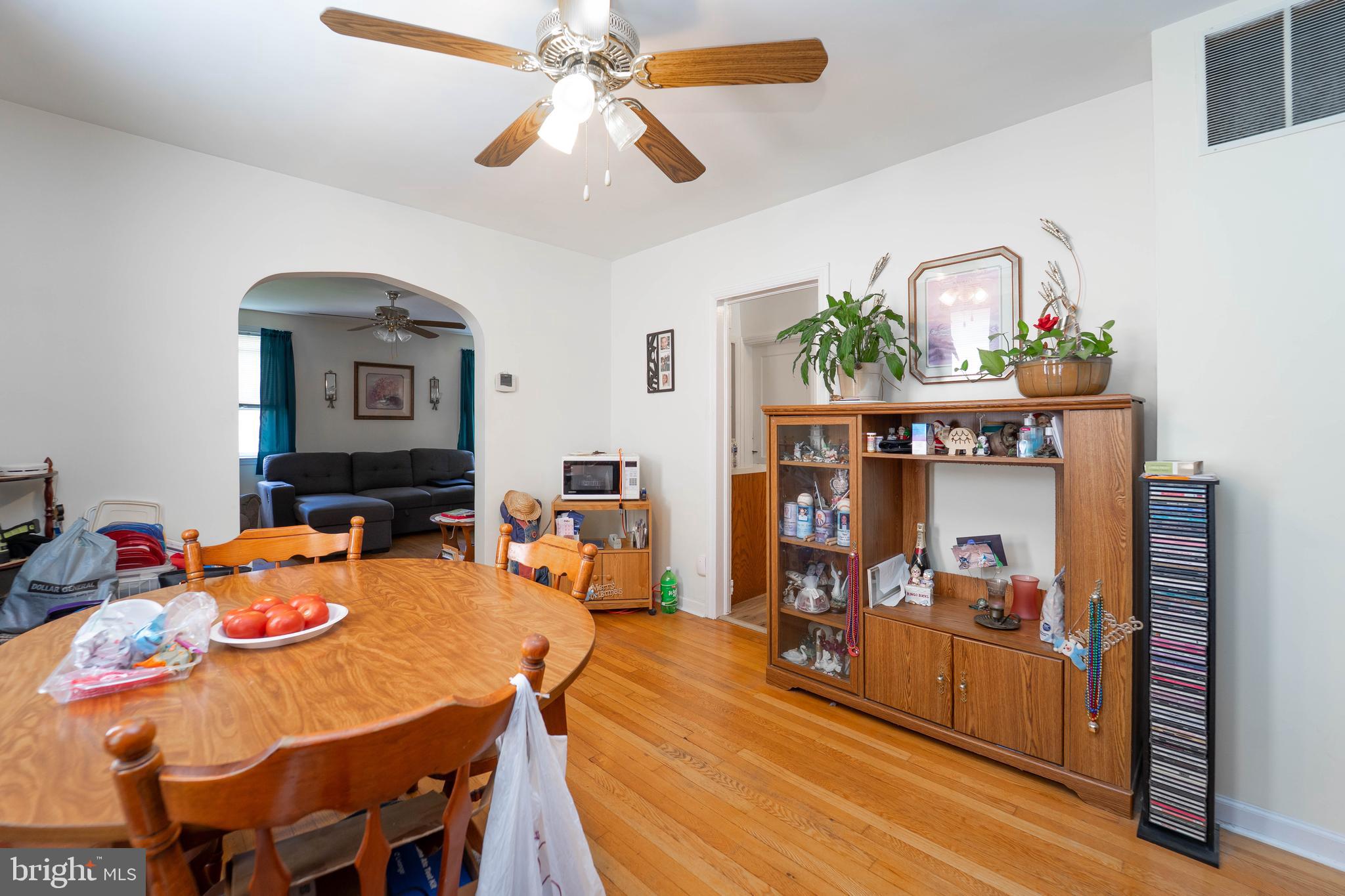 6515 Frederick Road Catonsville, MD 21228 - Photo 18 of 30 a view of a dining room with furniture and a chandelier fan