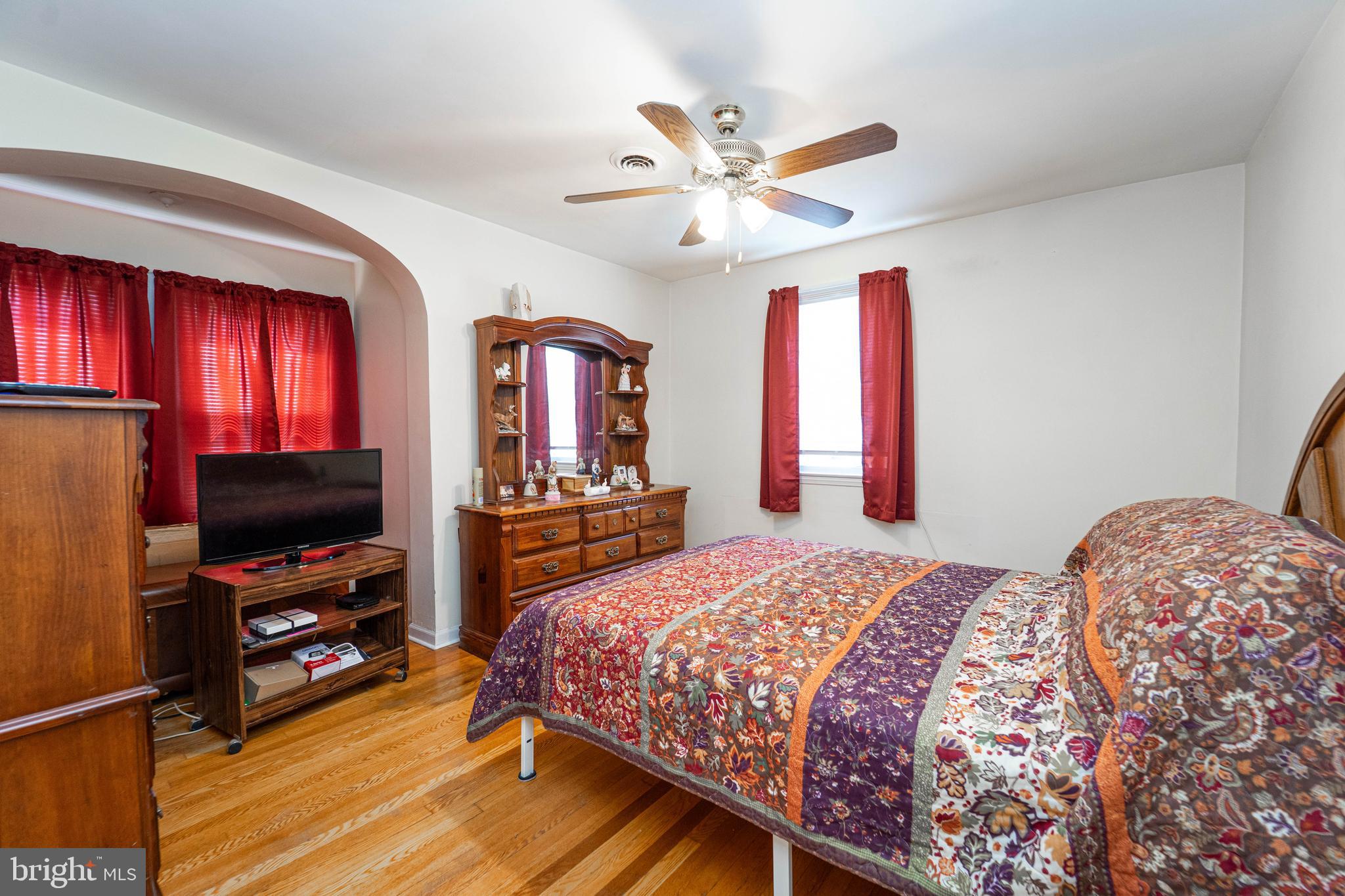 6515 Frederick Road Catonsville, MD 21228 - Photo 9 of 30 a bedroom with a bed and a flat screen tv