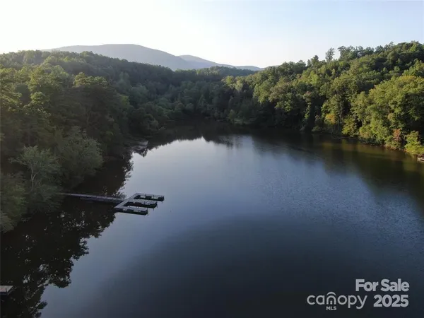 a view of a lake in middle of forest
