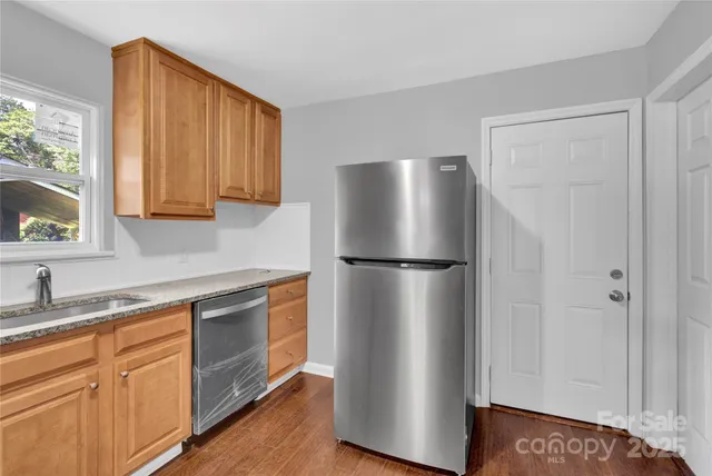 a kitchen with stainless steel appliances a refrigerator and a sink