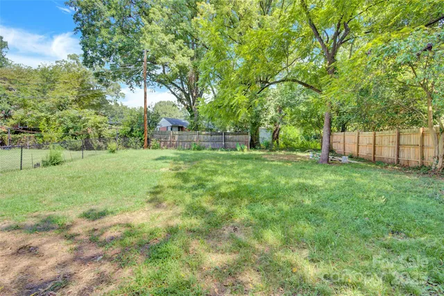 a view of a yard with a house in the background