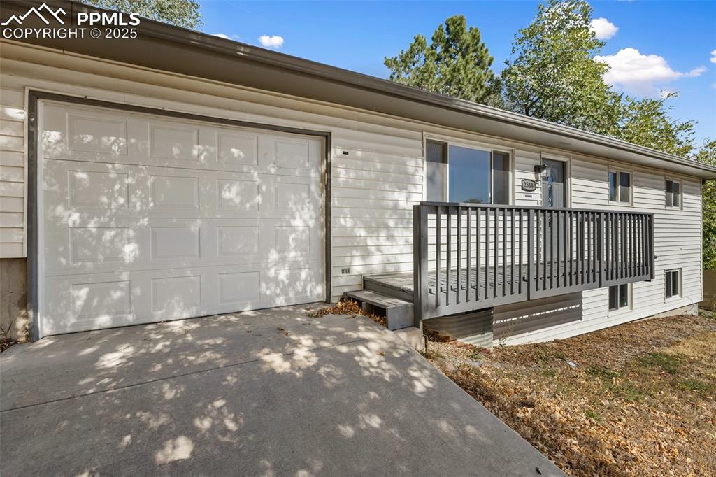 2518 Royalty Court Colorado Springs, CO 80904 - Photo 3 of 47 a view of a house with a small yard and wooden fence