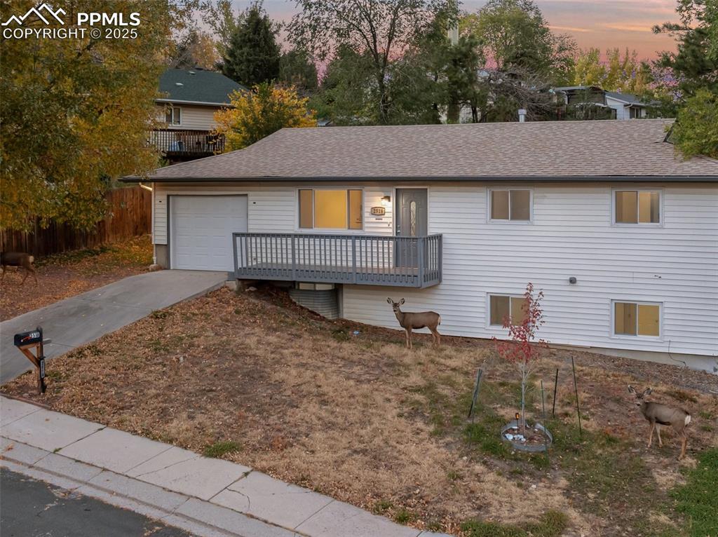 2518 Royalty Court Colorado Springs, CO 80904 - Photo 4 of 47 a aerial view of a house with a yard and garage