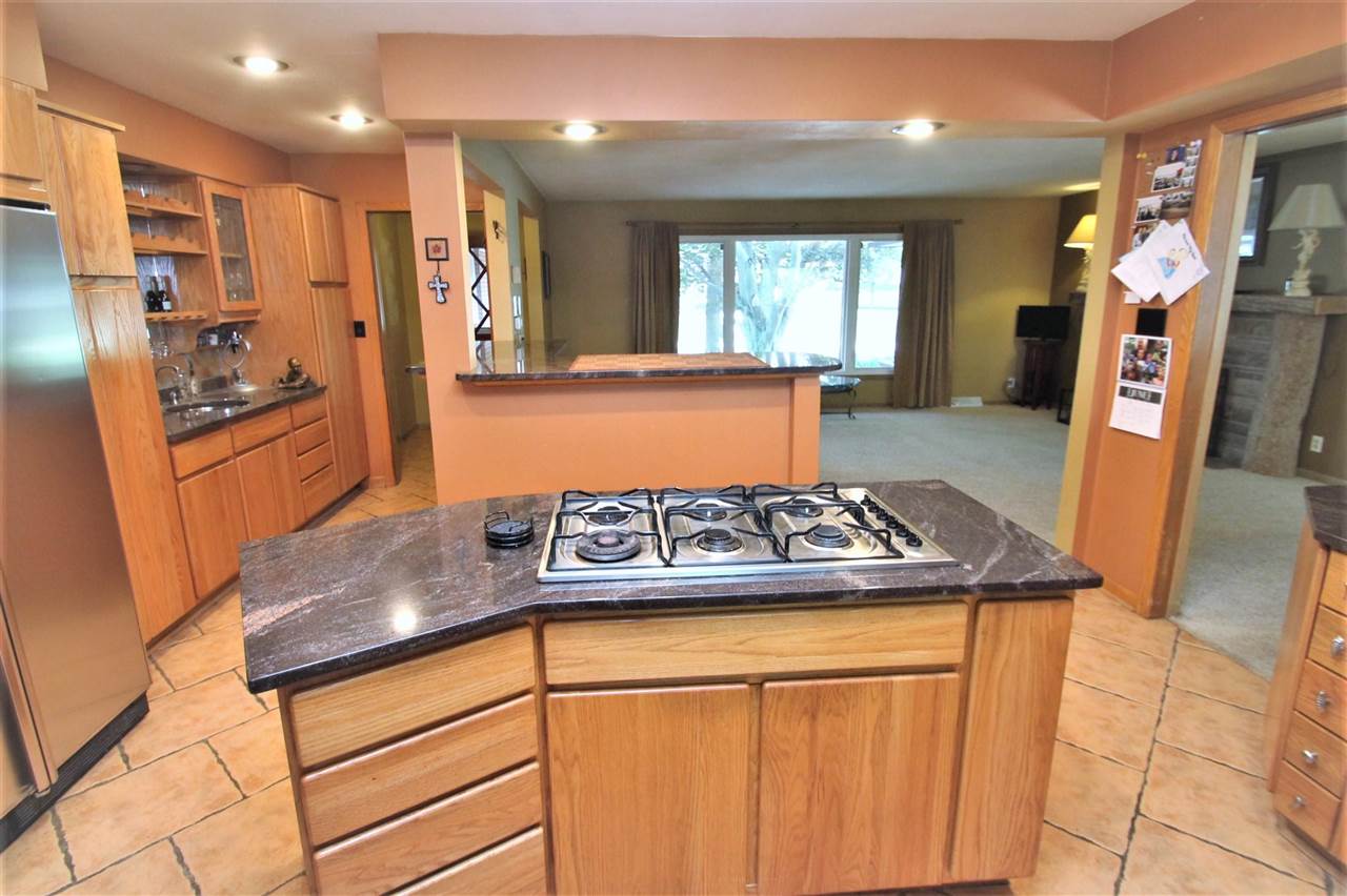 4118 Landstrom Road Rockford, IL 61114 - Photo 11 of 24 a kitchen with stainless steel appliances granite countertop a stove a sink and a refrigerator