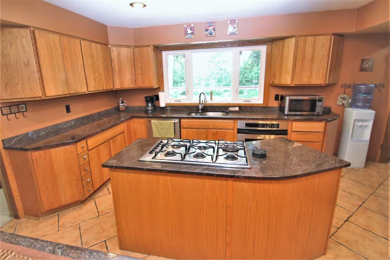 4118 Landstrom Road Rockford, IL 61114 - Photo 12 of 24 a kitchen with stainless steel appliances granite countertop a sink a stove and a refrigerator
