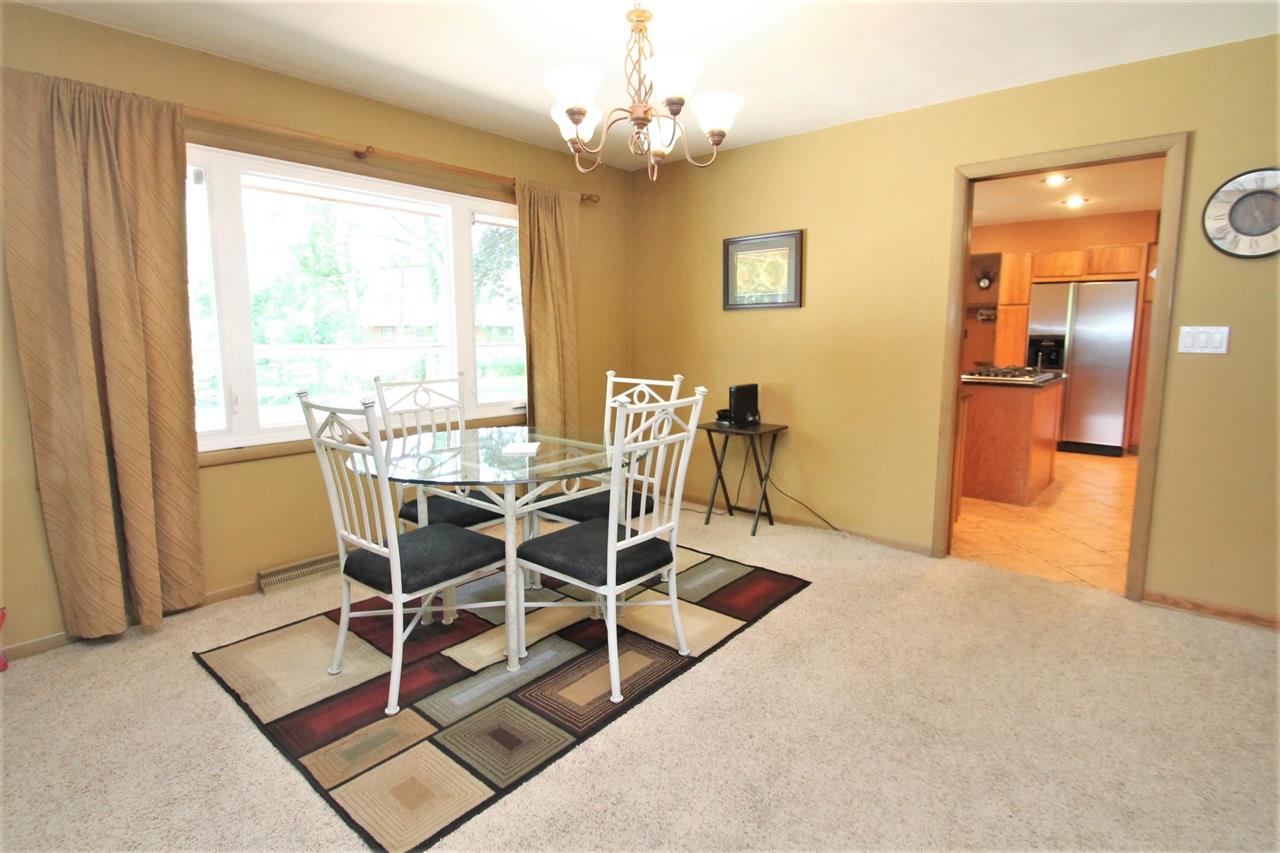 4118 Landstrom Road Rockford, IL 61114 - Photo 17 of 24 a view of a dining room with furniture and a chandelier
