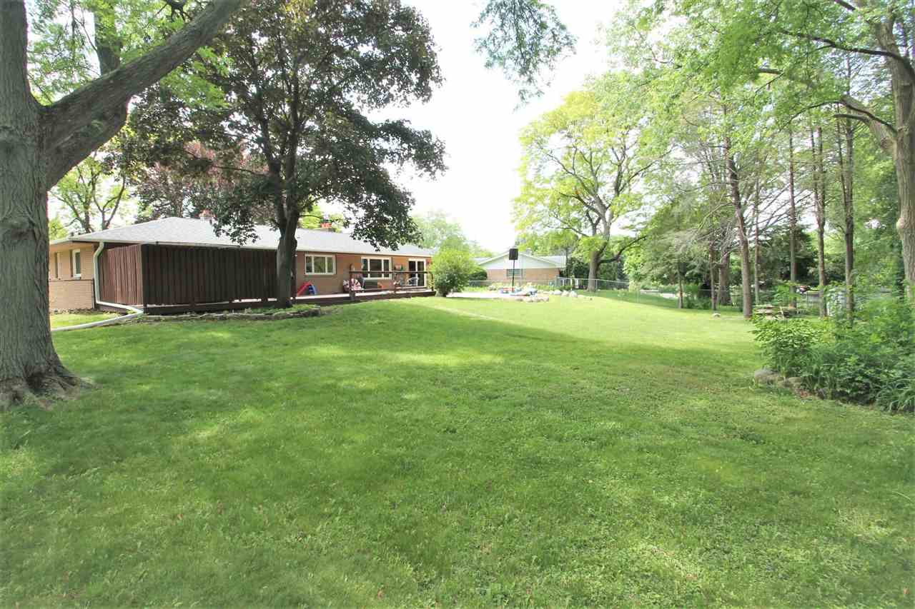 4118 Landstrom Road Rockford, IL 61114 - Photo 4 of 24 a view of a field of grass and trees