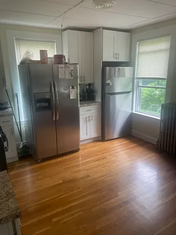 a metallic refrigerator freezer sitting in a kitchen