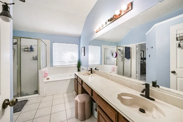 a bathroom with a sink double vanity and a tub