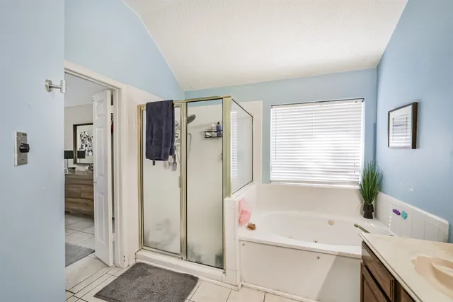 a bathroom with a tub sink and shower