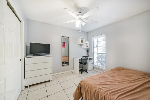 a bedroom with a bed and a television