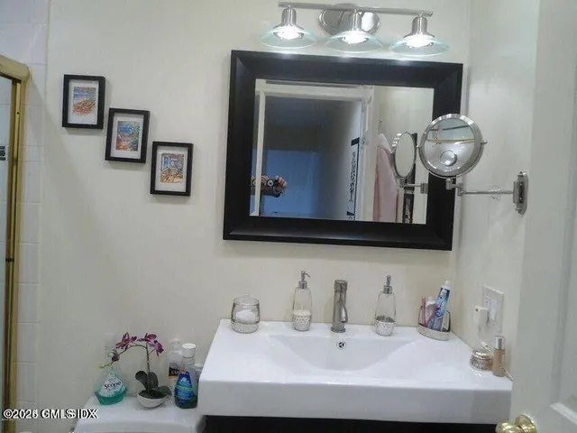 a bathroom with a sink and a mirror