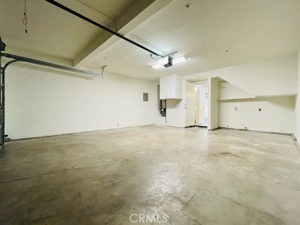a view of an empty room with furniture and closet