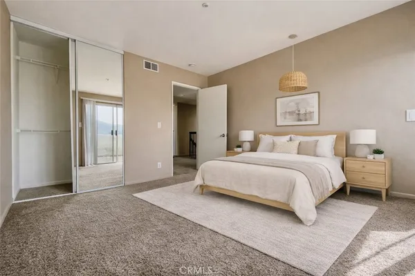 a spacious bedroom with a bed and a couch