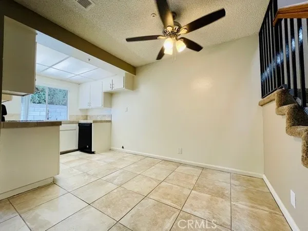 a view of a kitchen with a sink and a refrigerator