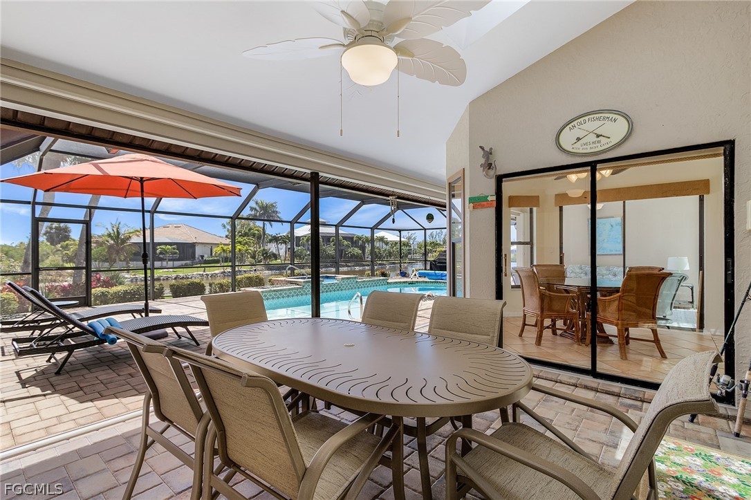 7747 Grande Pine Road Bokeelia, FL 33922 - Photo 31 of 45 a view of a dining room with furniture large windows and chairs