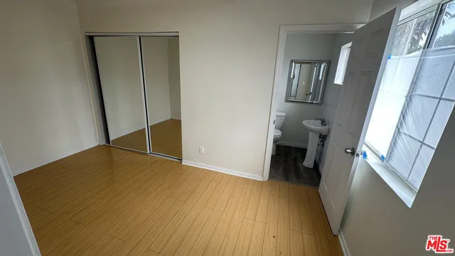 a view of a room with wooden floor and staircase