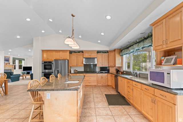 1133 Paris Canyon Road Paris, ID 83261 - Photo 8 of 74 Kitchen featuring light wood cabinetry, granite countertops, tile flooring, stainless steel appliances, and a vaulted ceiling with recessed lighting