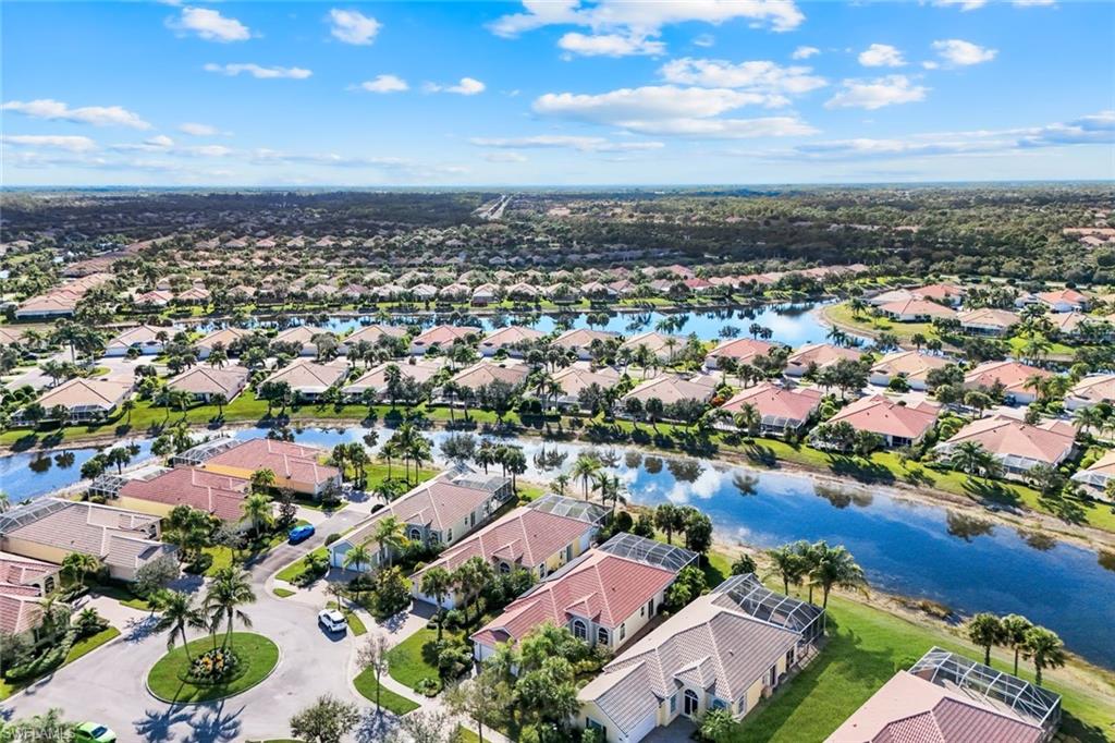 7063 Toscana Court Naples, FL 34114 - Photo 2 of 47 Aerial view of residential area featuring a nearby body of water
